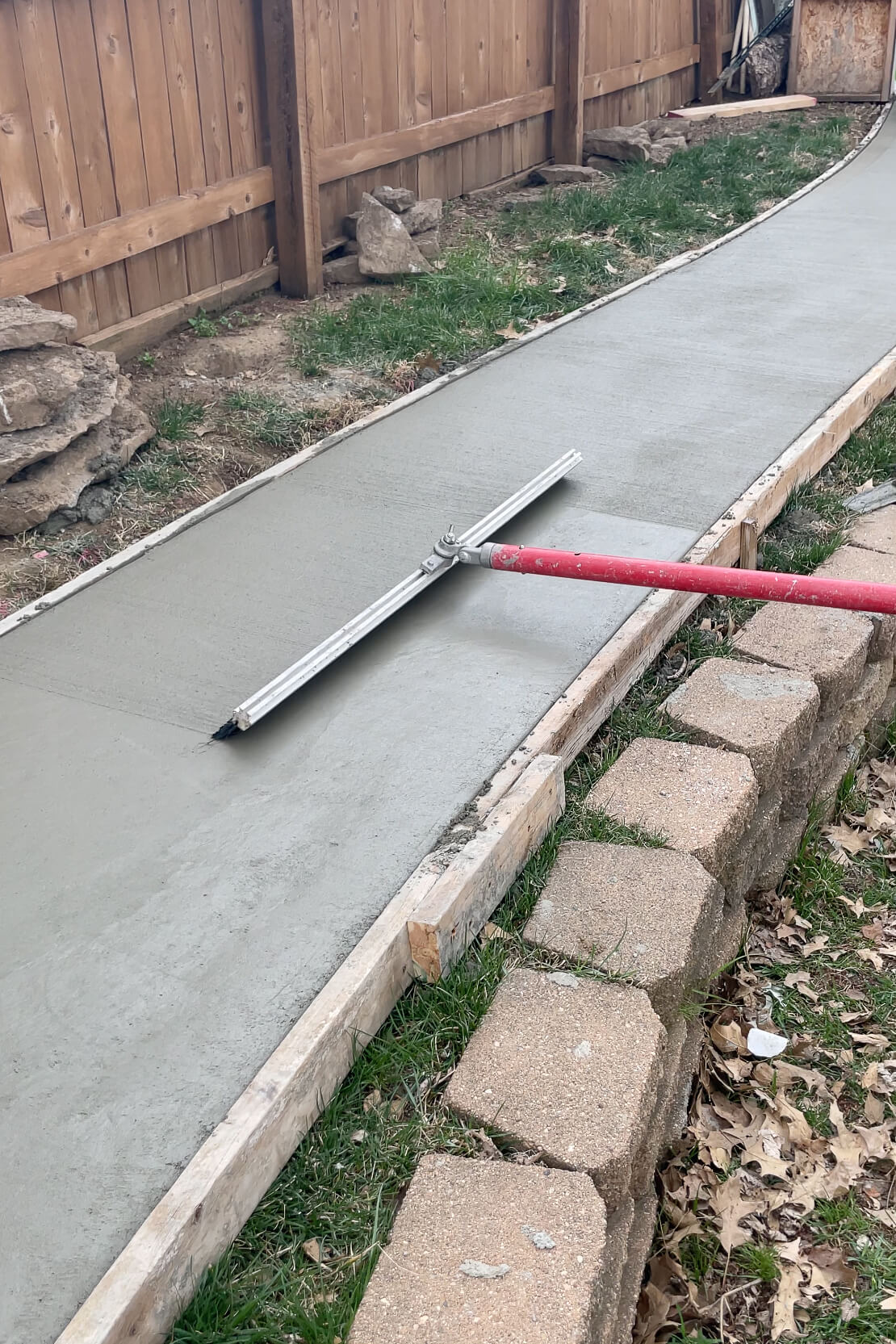 Brushing the freshly poured concrete.